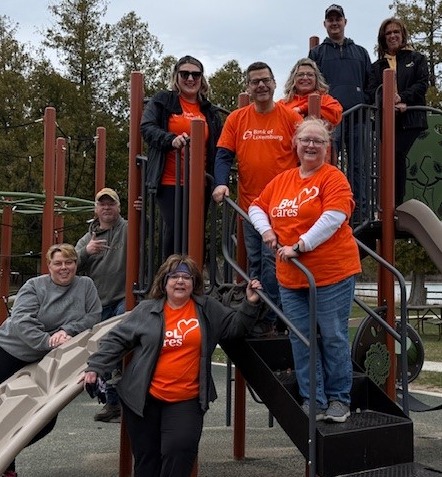 Group of volunteers posing for a picture on a playground set